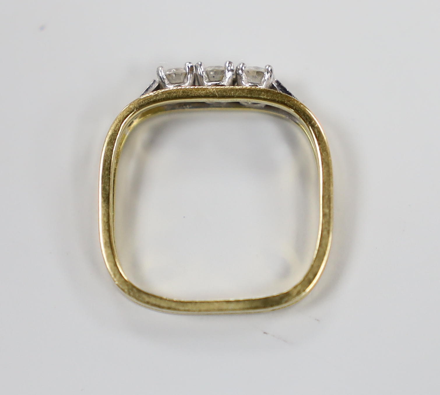 A modern 18ct and three stone diamond ring, with square shank, size approx. L/M, gross weight 2.9 grams.